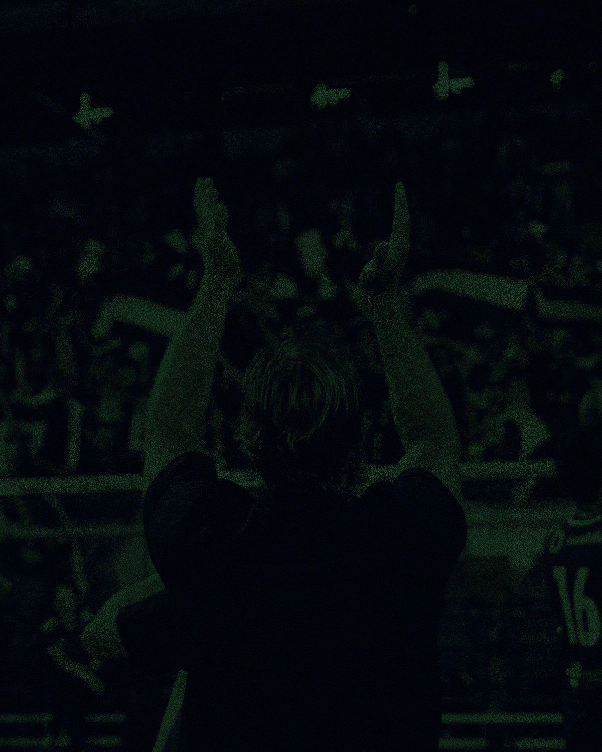 Footballer celebrating in front of supporters